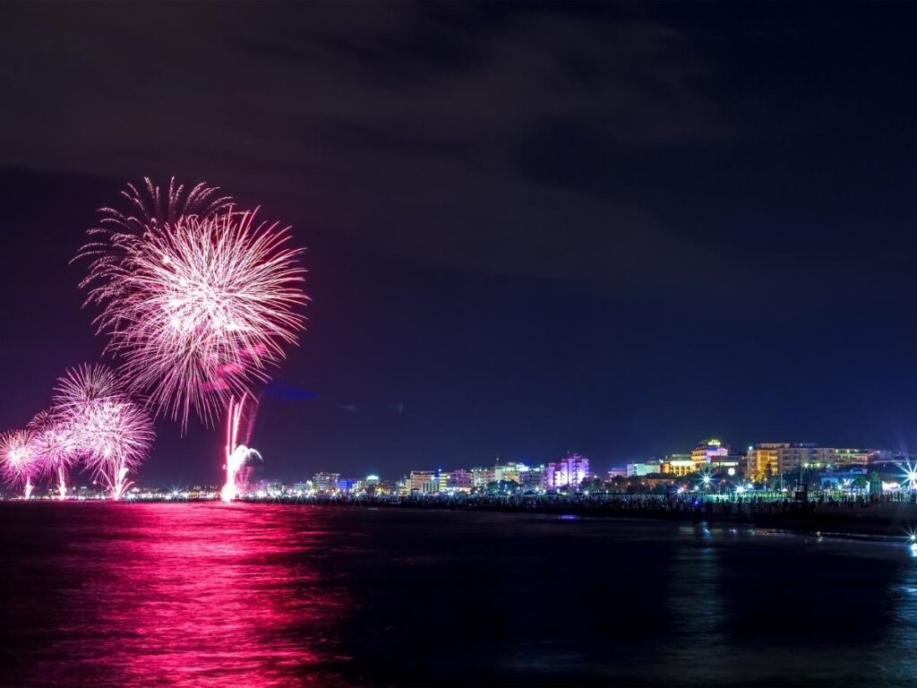 Fireworks and pink lights along Rimini beach during La Notte Rosa festival