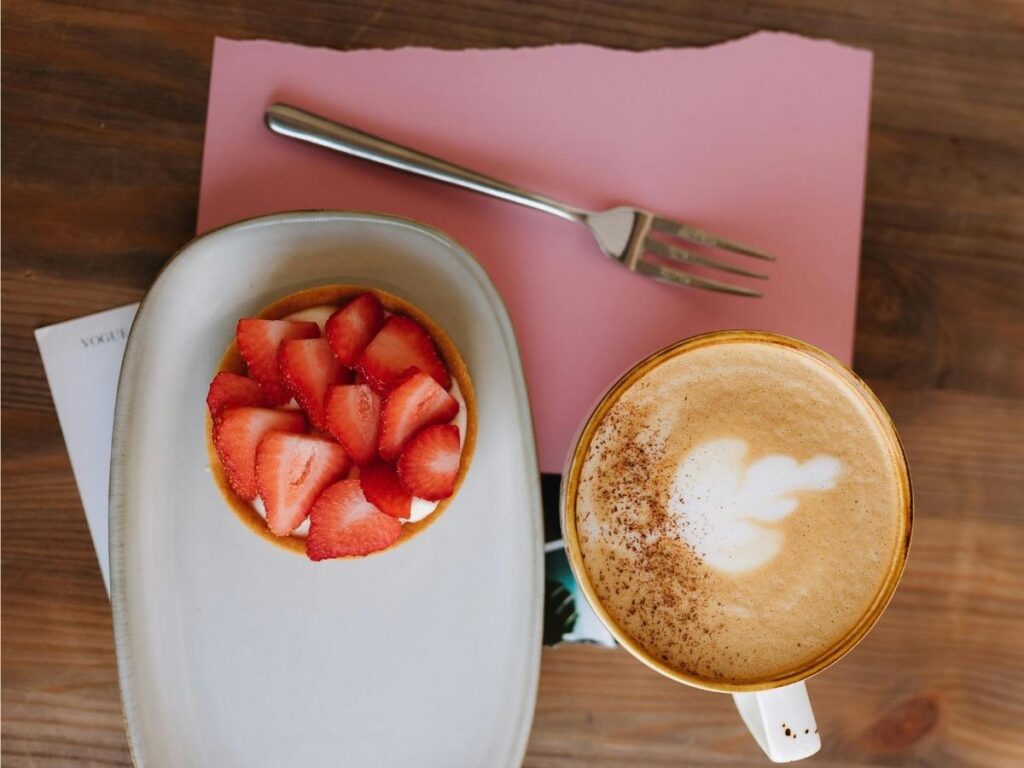 Wild strawberries and a coffee on a table overlooking Lake Nemi