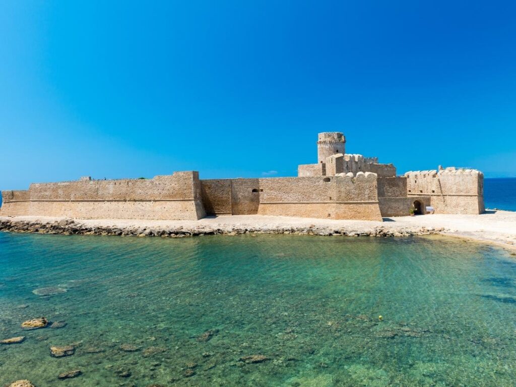 Aragonese fortress of Le Castella surrounded by turquoise Ionian Sea waters