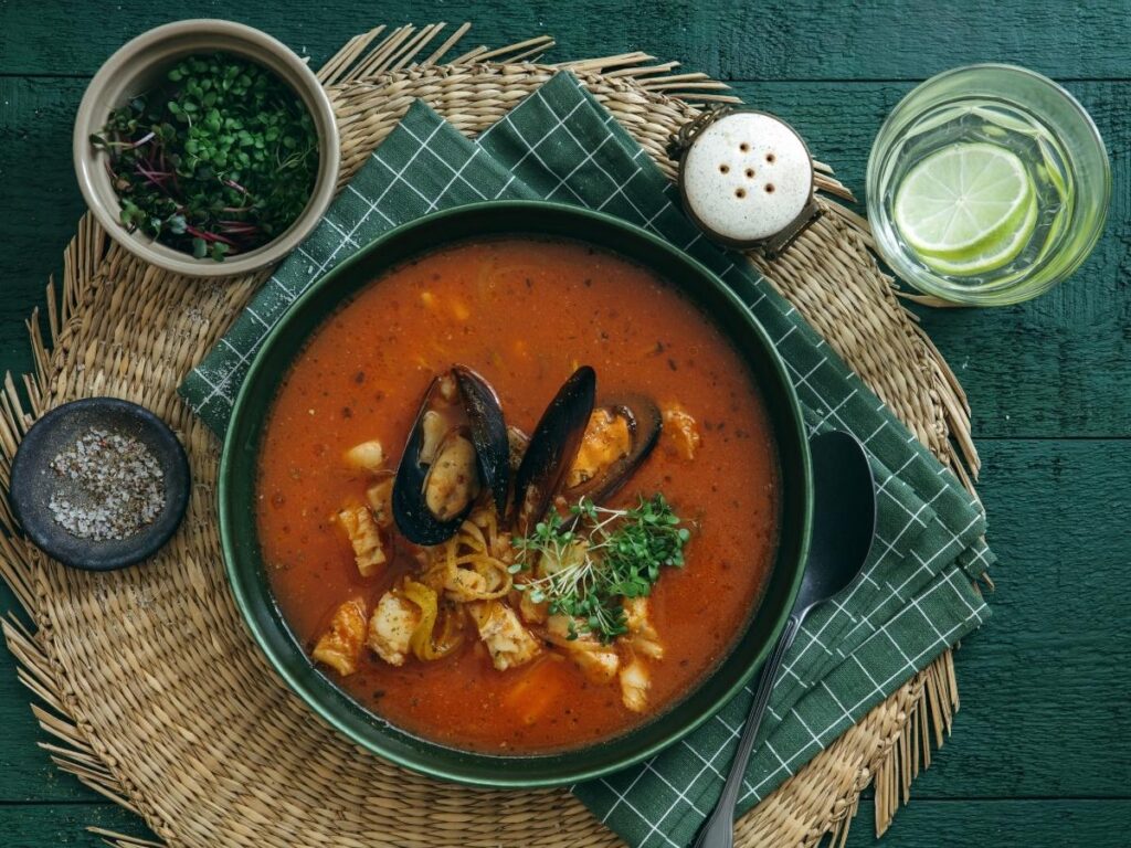 Traditional Tuscan cacciucco seafood stew served in Livorno with toasted bread.