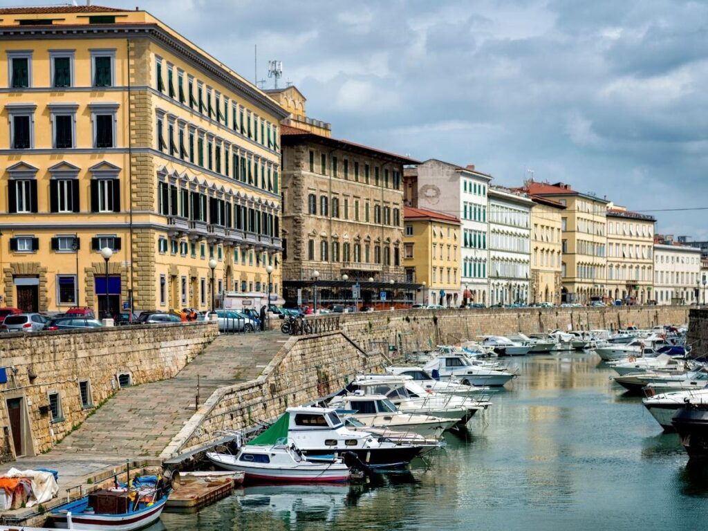 Canals in Livorno’s Venezia Nuova district with boats and pastel houses.