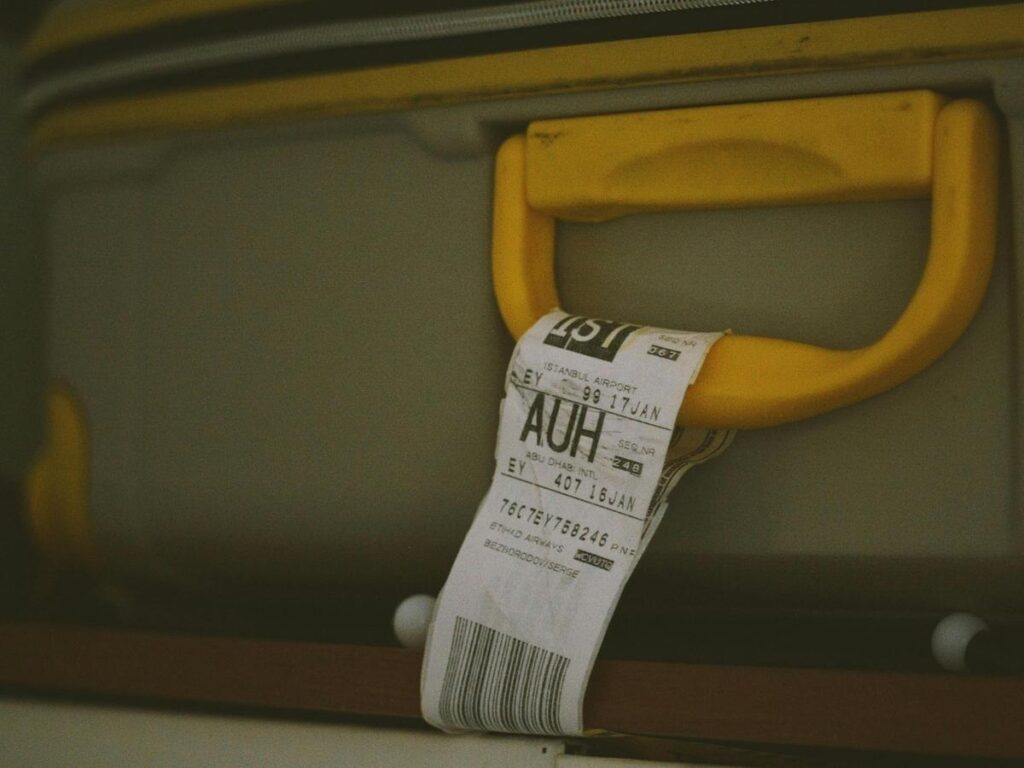 Close-up of an airline luggage tag with barcode and flight information.