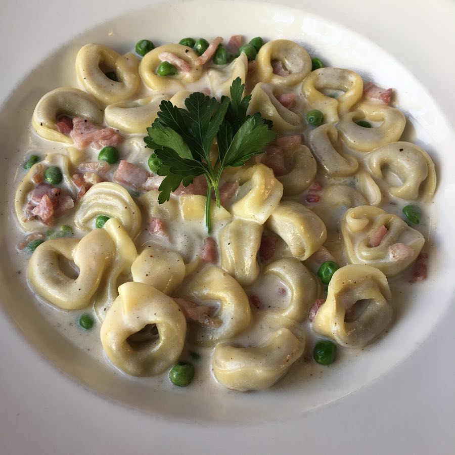 Handmade tortellini in rich broth.