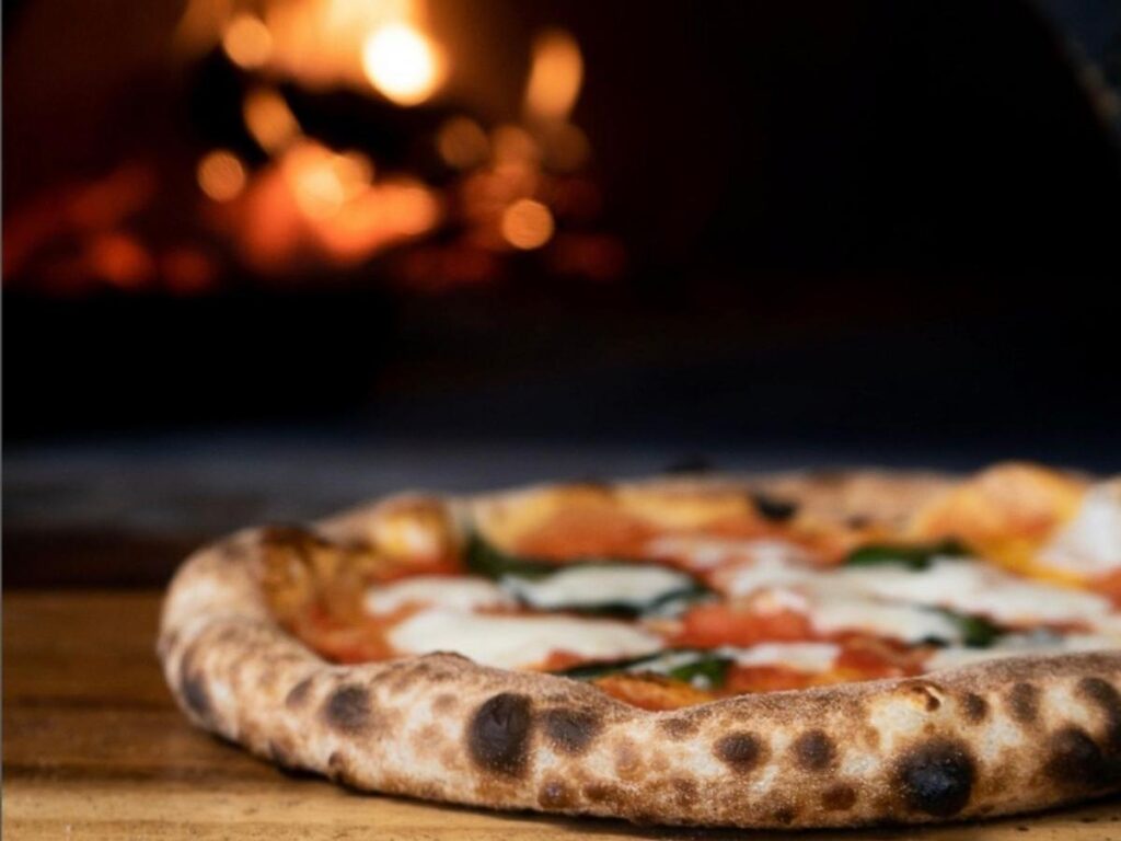 Traditional Neapolitan Margherita pizza fresh from a wood-fired oven.