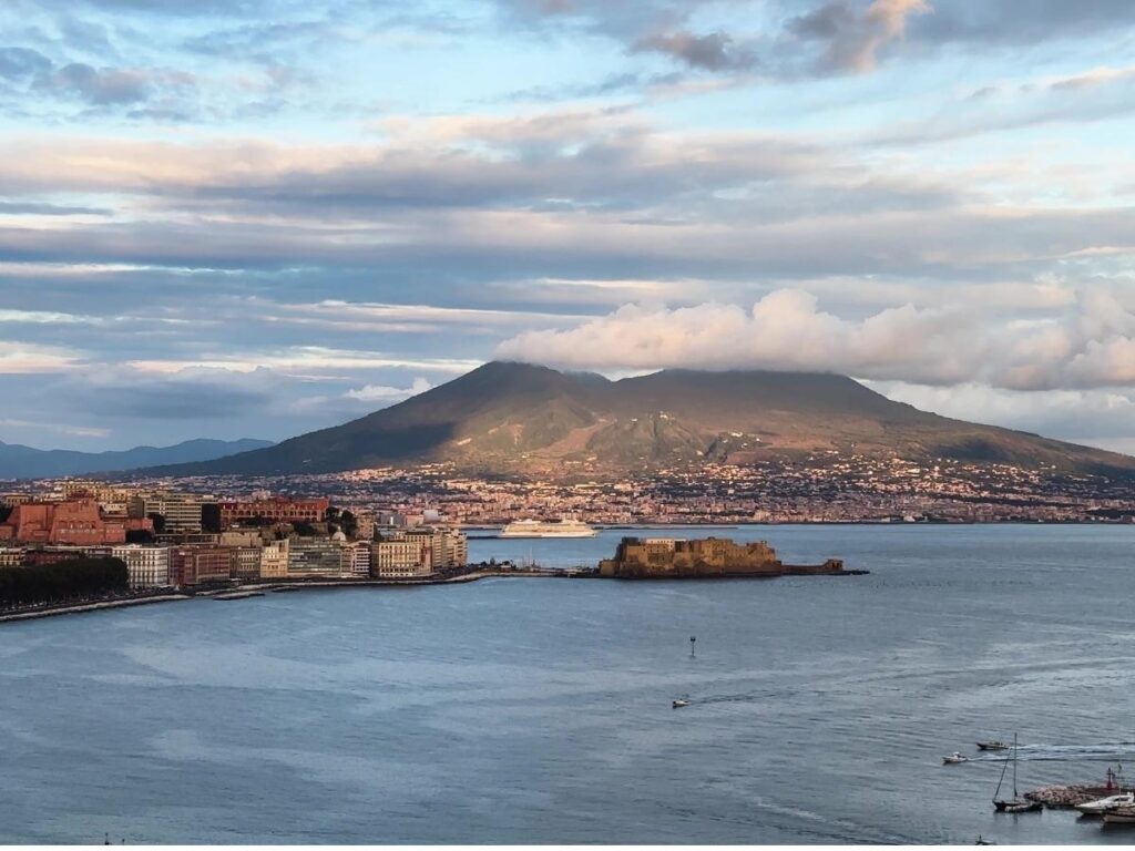 Naples city rooftops with Mount Vesuvius looming in the background.