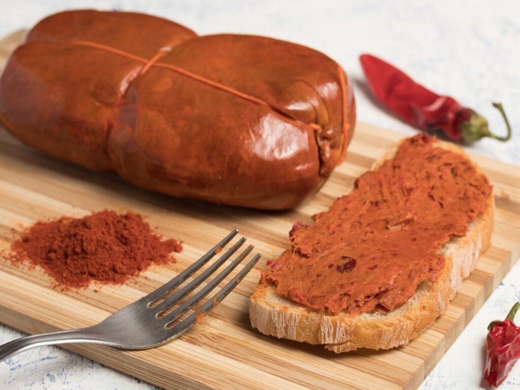Calabrian nduja spread on rustic bread with chili peppers on the side