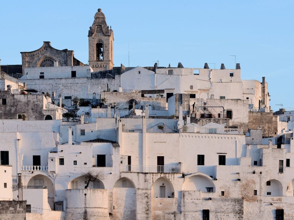 Panoramic view of Ostuni, the White City, rising above olive groves.