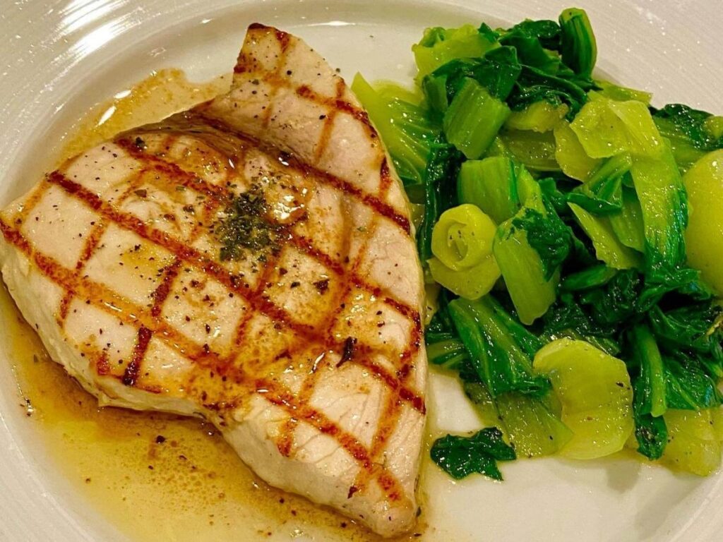 Grilled pesce spada (swordfish) served with lemon and herbs