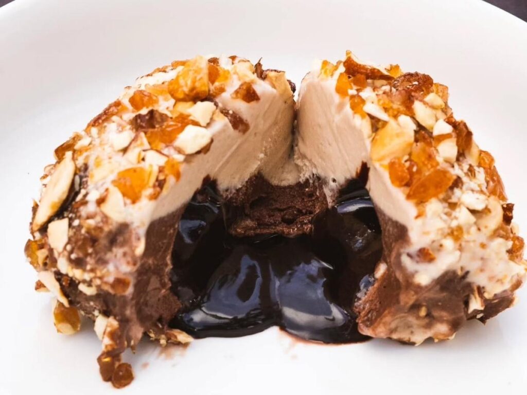 A slice of tartufo gelato on a plate at Bar Ercole, Pizzo, Calabria.”