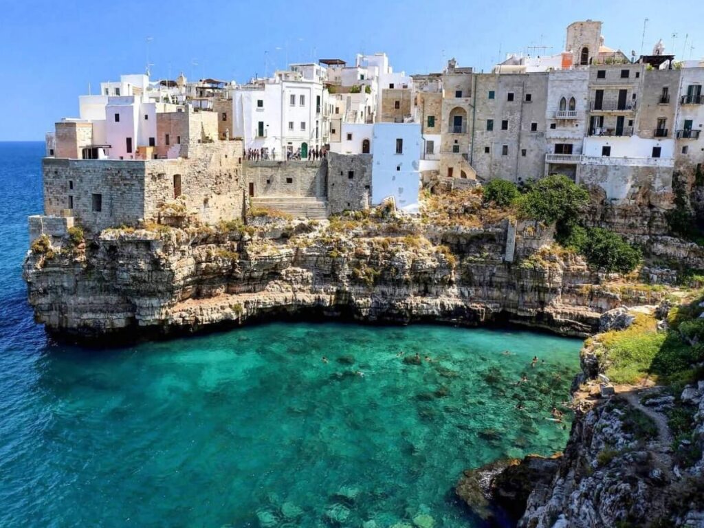 Cliffside town of Polignano a Mare with turquoise waters and Lama Monachile beach.