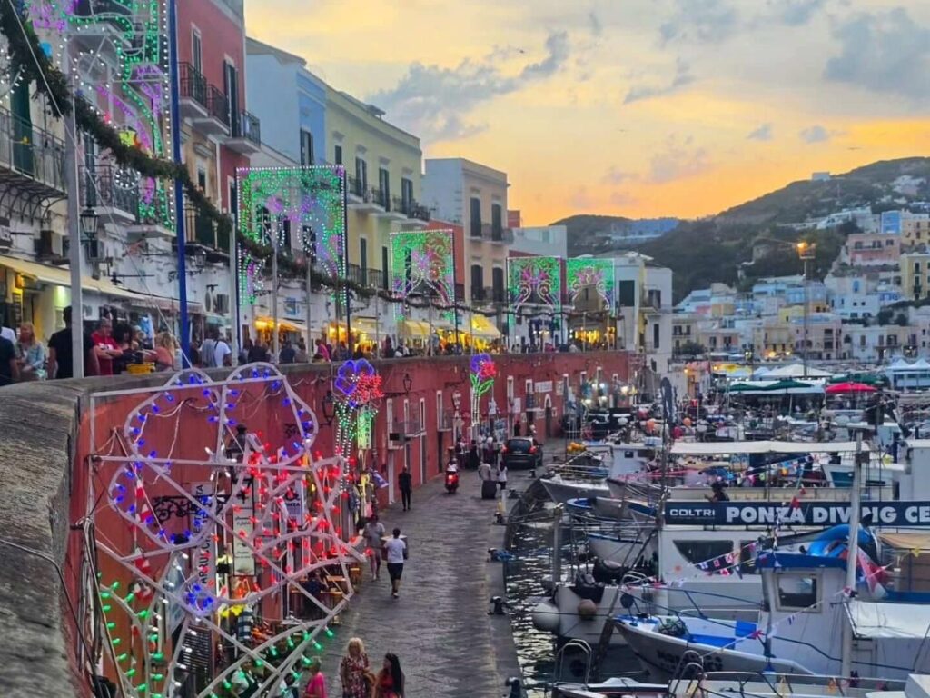 Small boat approaching the turquoise cliffs of Palmarola near Ponza