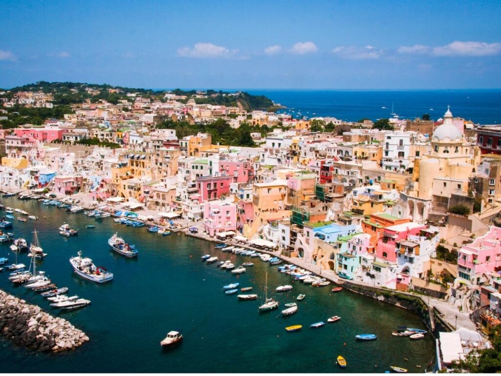 Bright pastel fishing houses around Marina Corricella in Procida.