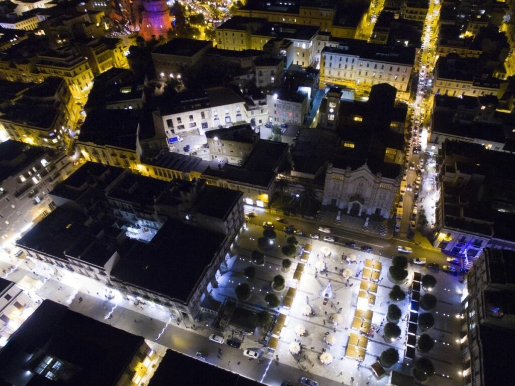 City hotel in Reggio Calabria lit up at night near the promenade.”