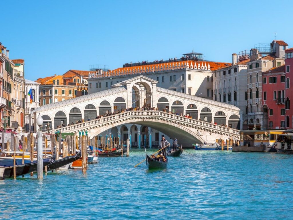 Early morning at Rialto Market with fresh fish stalls and Rialto Bridge in the background