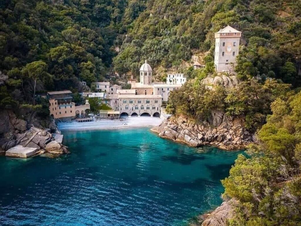 San Fruttuoso Abbey with its arches opening directly onto the pebble beach and turquoise sea.