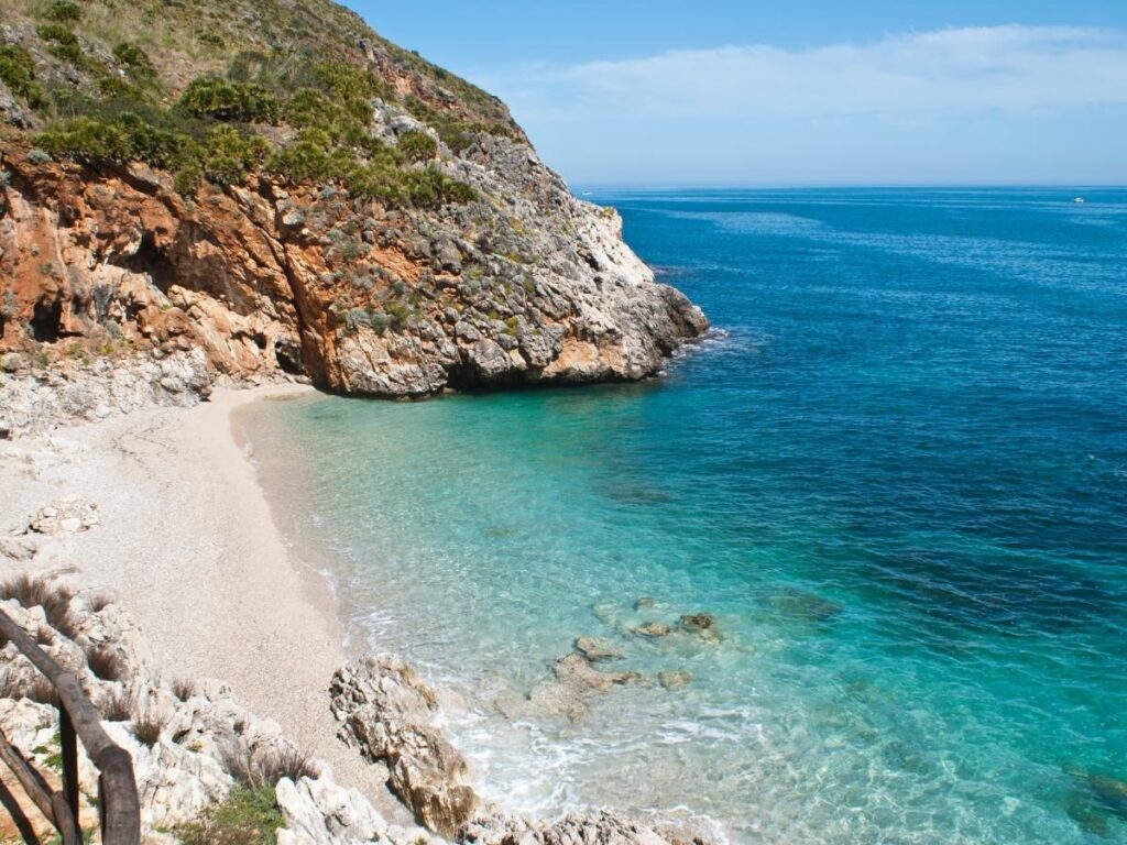 Hidden cove and turquoise water seen from a coastal walking trail in Zingaro Nature Reserve.
