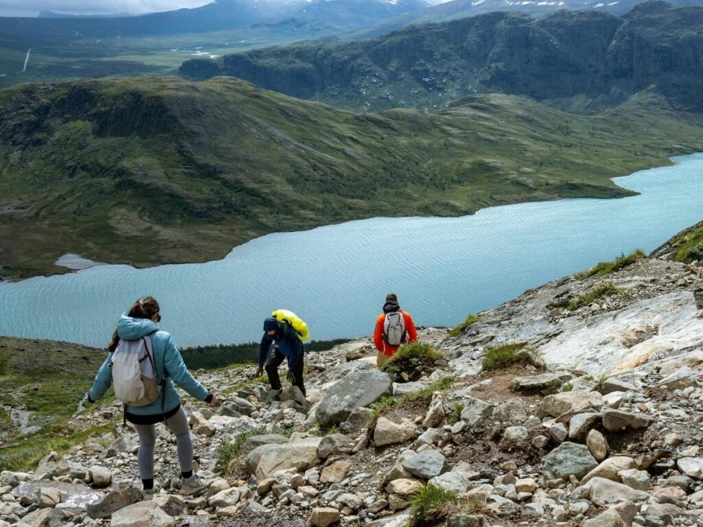 Walking trail along Lake Cecita in Sila National Park surrounded by tall pines.”