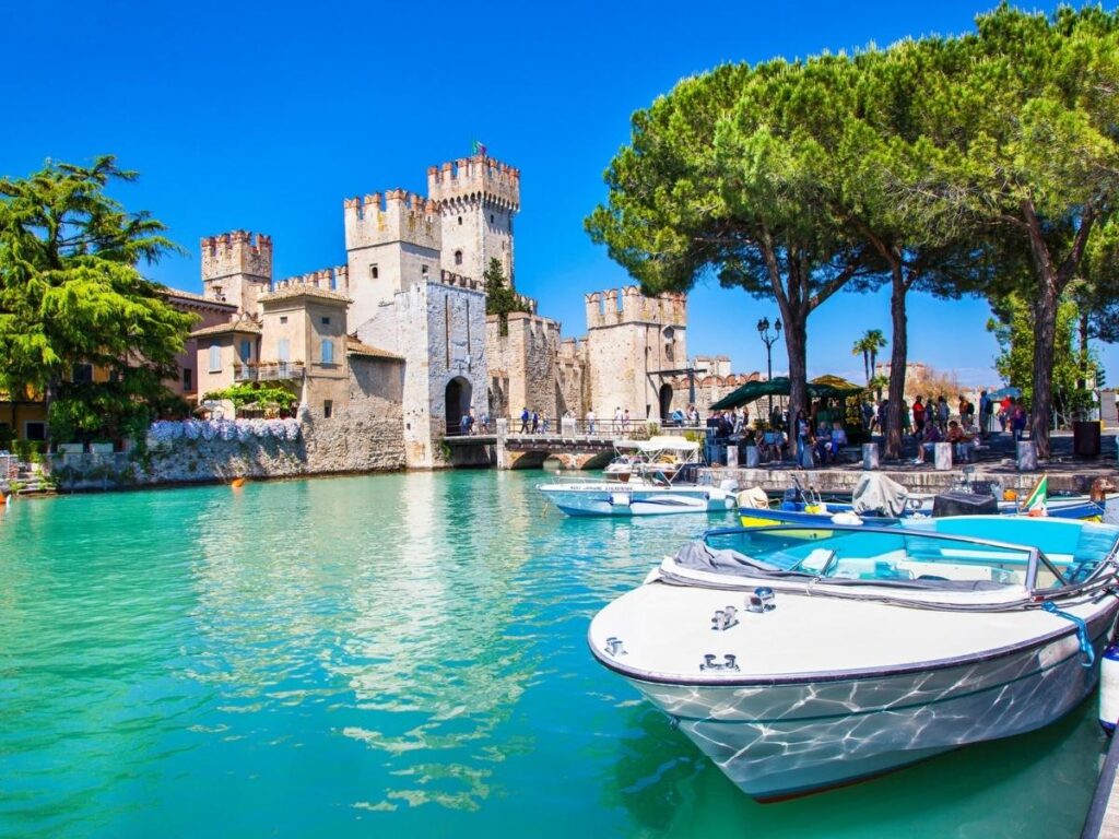 Castle at Sirmione with the narrow finger of Lake Garda and castle walls.