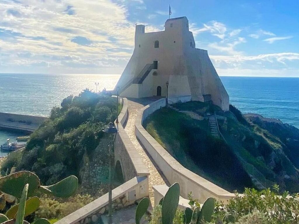 Whitewashed houses and sandy beach in Sperlonga at midday"
