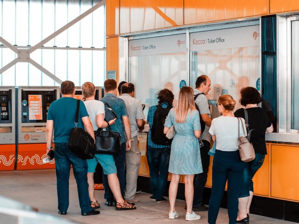 Tourists buying attraction tickets at a counter
