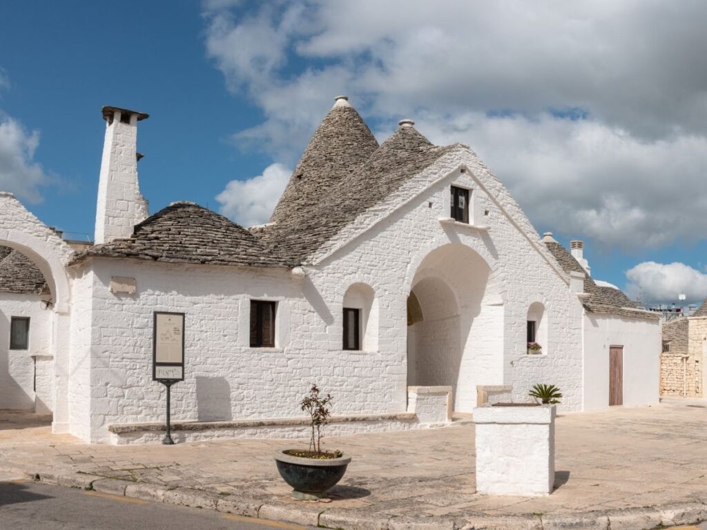 Exterior of the two-story Trullo Sovrano in Alberobello, open as a museum.