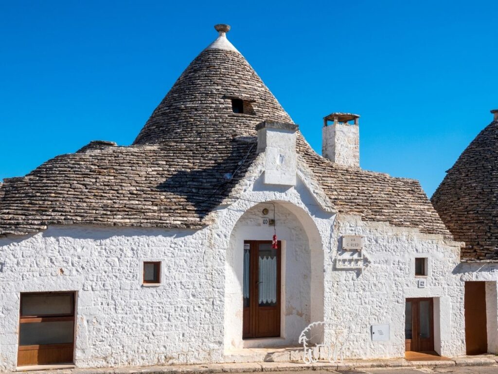 Restored trullo accommodation with stone walls and cozy interiors near Alberobello.