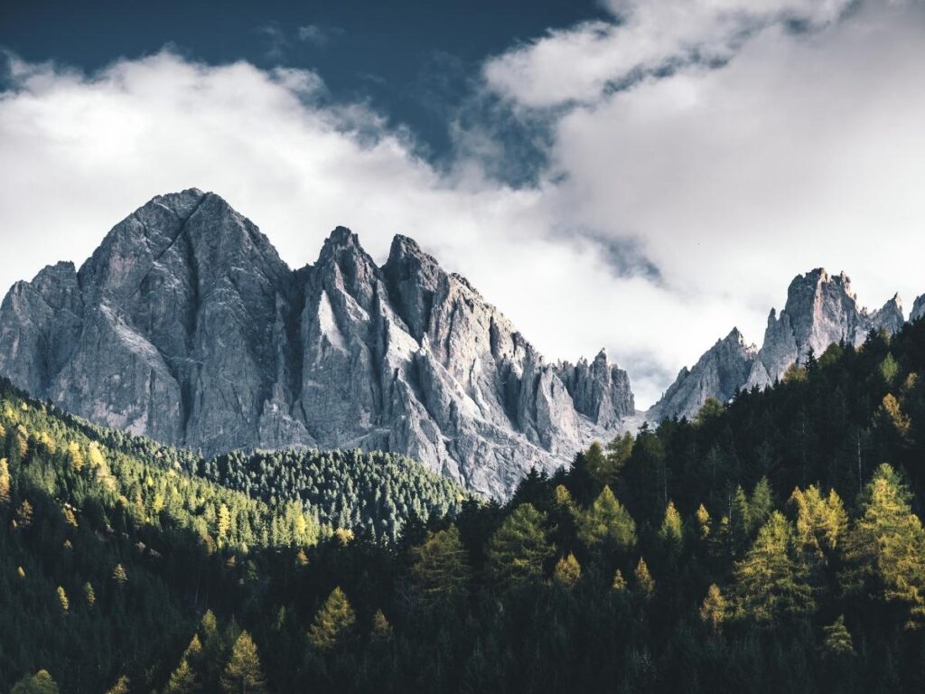 Santa Maddalena church in Val di Funes with Odle mountain peaks glowing at sunset in the Dolomites.