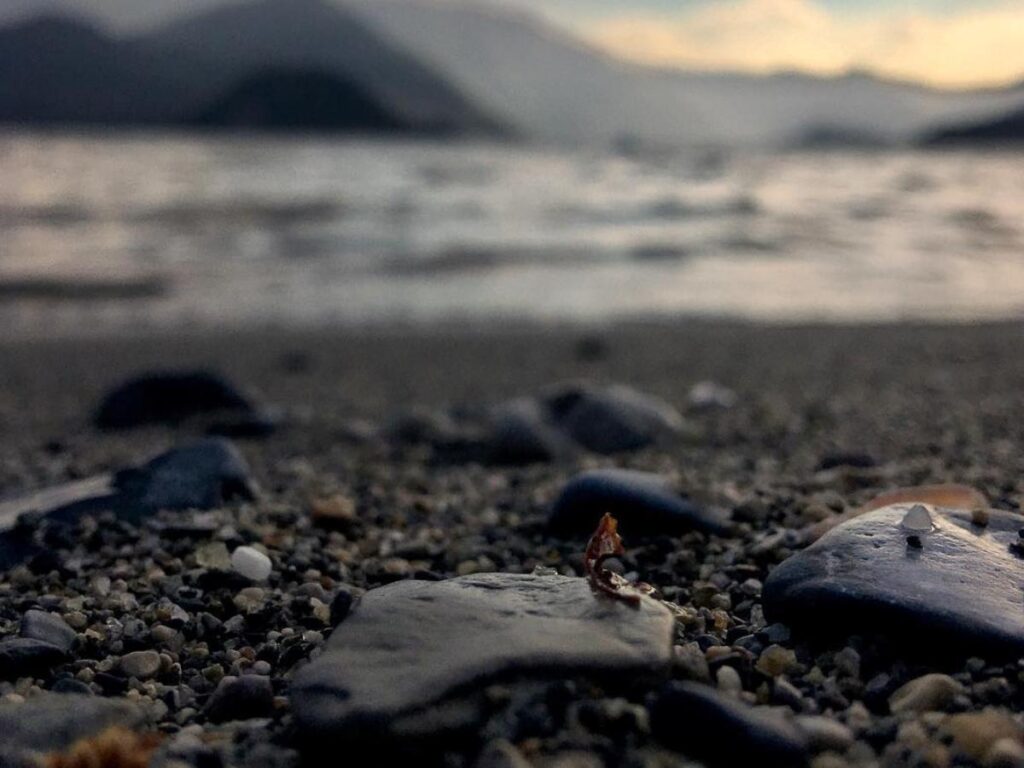 Quiet stone jetty in Varenna looking out across the lake at early evening.