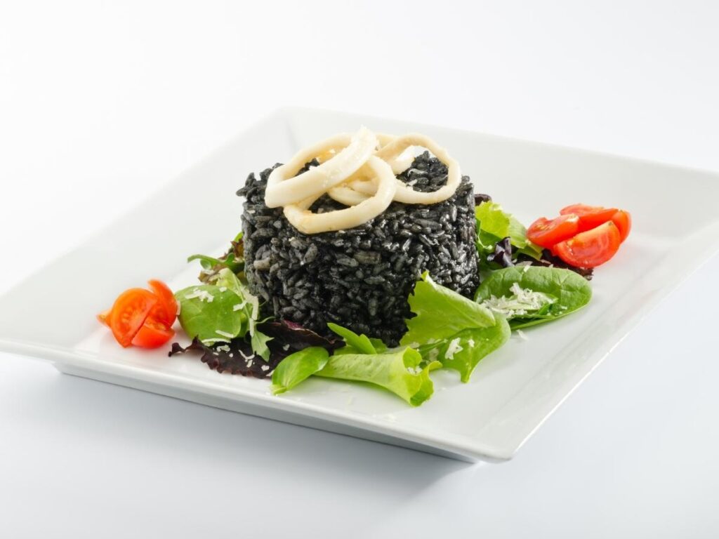 Squid ink risotto served in a traditional Venetian trattoria