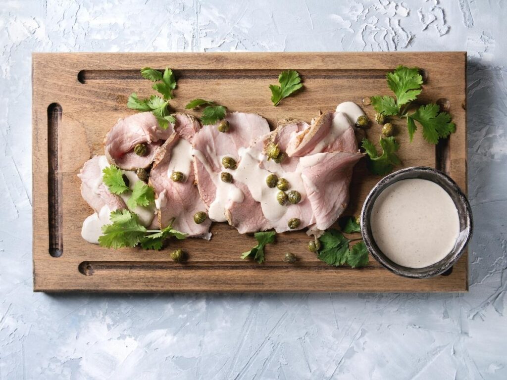 Slices of vitello tonnato veal with tuna-caper sauce served in Turin