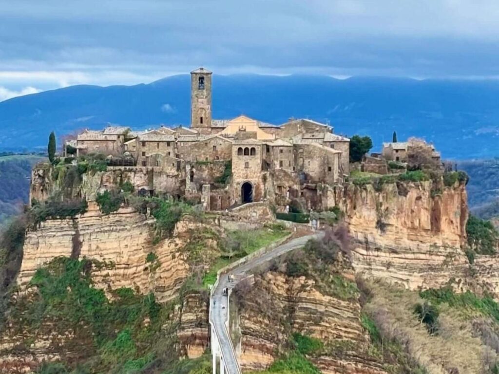 Medieval stone alley in Viterbo lit by lanterns at night