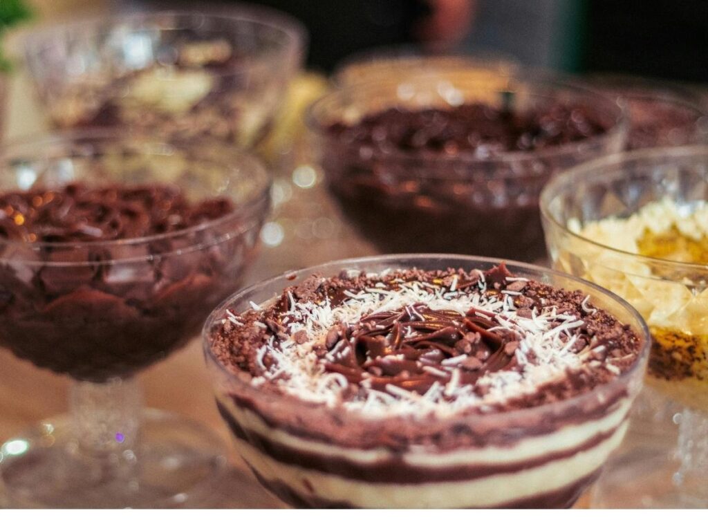 A slice of zuppa inglese with layers of sponge cake, custard, and pink Alchermes liqueur