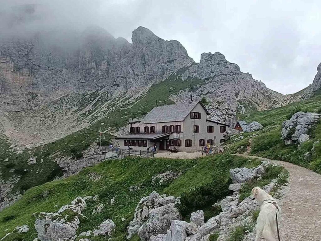 Mountain hut in Gran Paradiso at sunset with climbers preparing for a summit attempt.