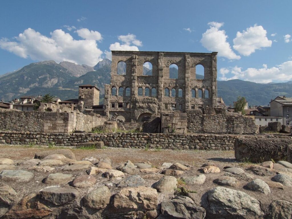 Aosta’s Roman Theatre ruins with the Alps rising dramatically in the background.