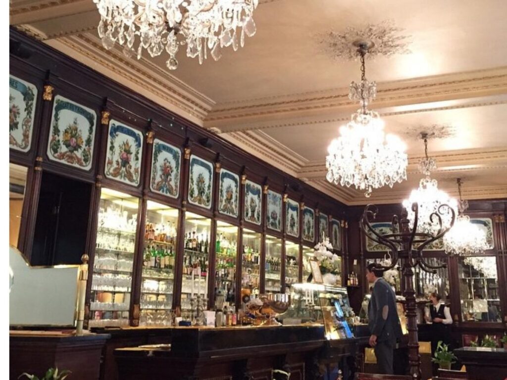 Cappuccino and pastry on marble counter at Baratti & Milano café, Turin.