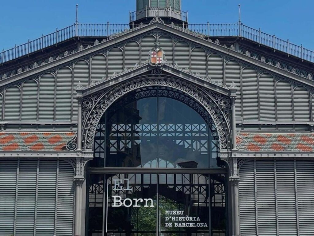Street musician playing guitar in El Born at golden hour