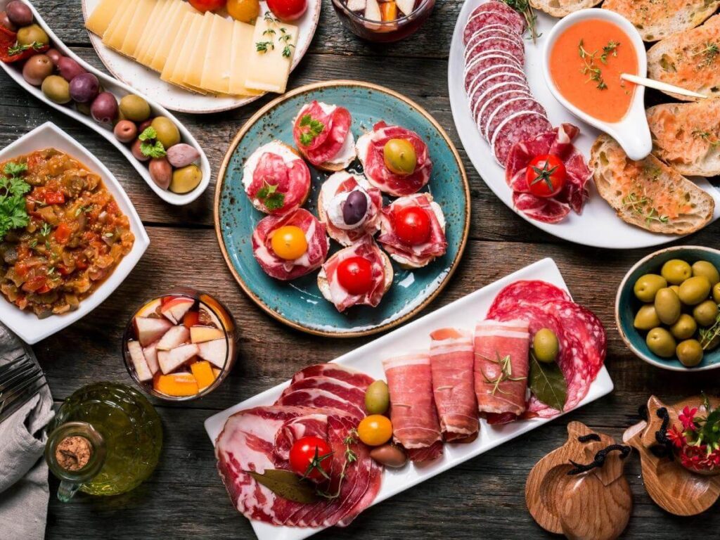Tapas and cava glasses on a wooden table in Barcelona restaurant