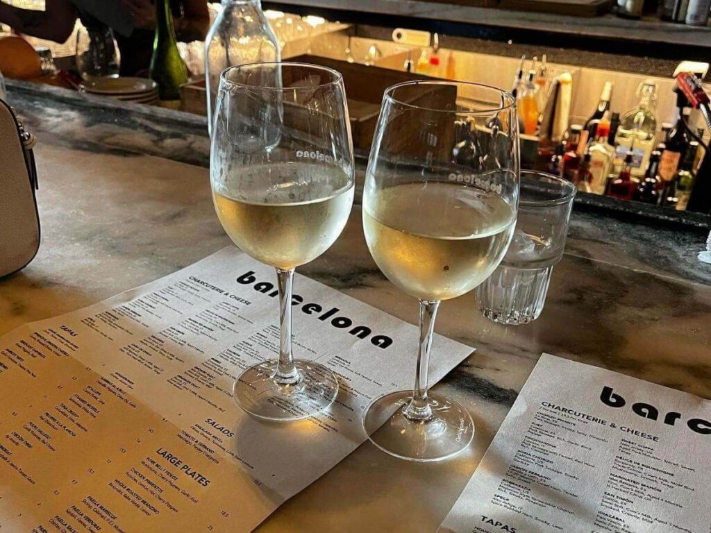 Cozy Barcelona wine bar with mismatched chairs and warm lighting