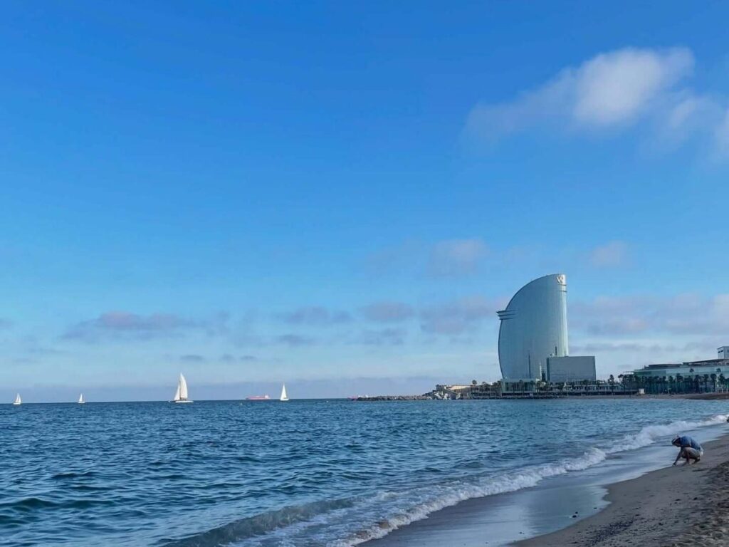 People drinking beer at Barceloneta beach at sunset