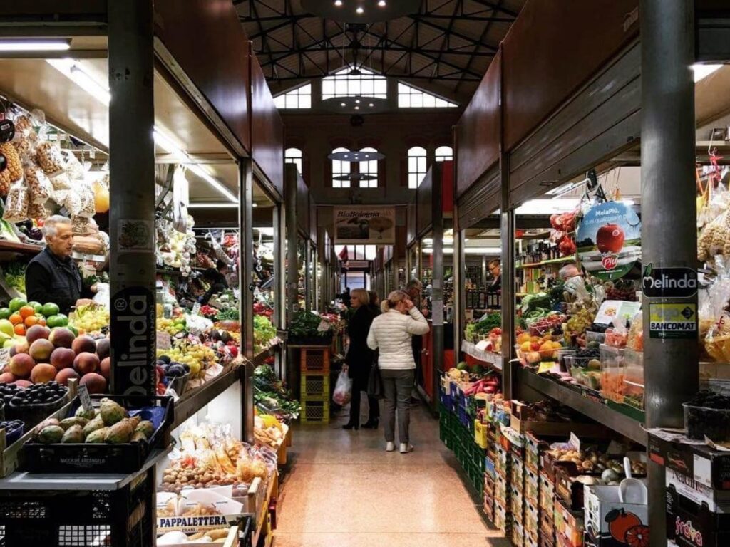 Interior of Mercato delle Erbe with counters and shoppers, Bologna”