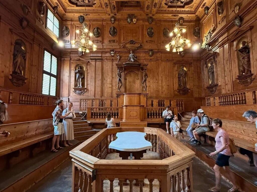Wooden benches and statues inside the Anatomical Theatre at Archiginnasio, Bologna