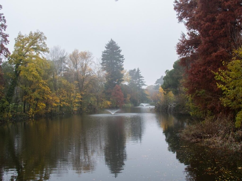 Locals relaxing by the pond at Giardini Margherita park, Bologna