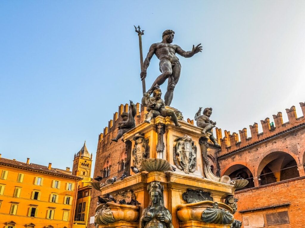 Morning sunlight over Piazza del Nettuno with the Fountain of Neptune and cafés opening, Bologna