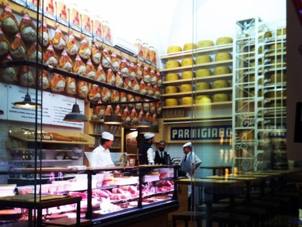 Butcher and cheese stalls in the Quadrilatero market, Bologna”