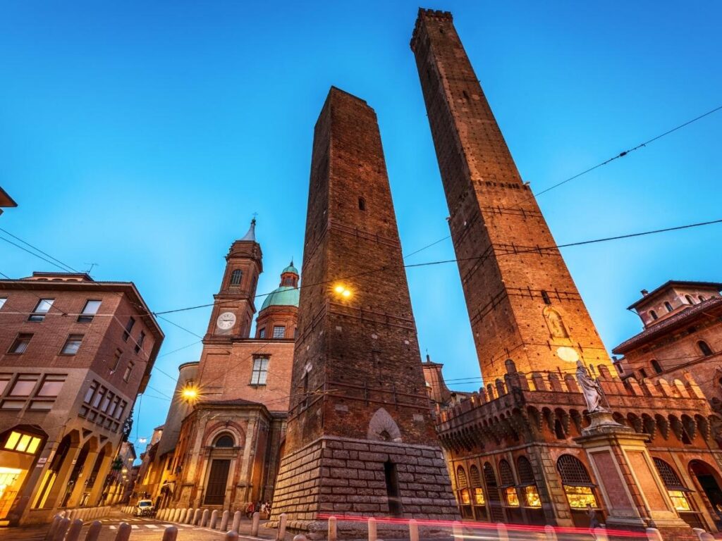 Asinelli and Garisenda towers rising above Via Rizzoli, Bologna.