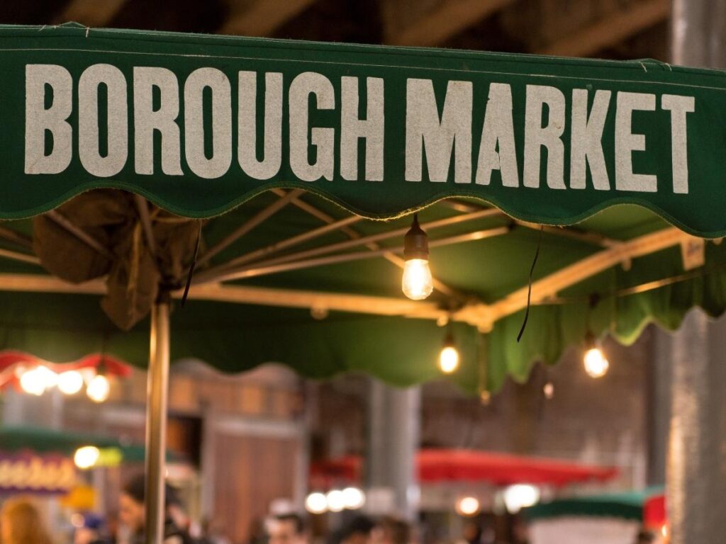 Borough Market in London filled with street food stalls and visitors during lunchtime