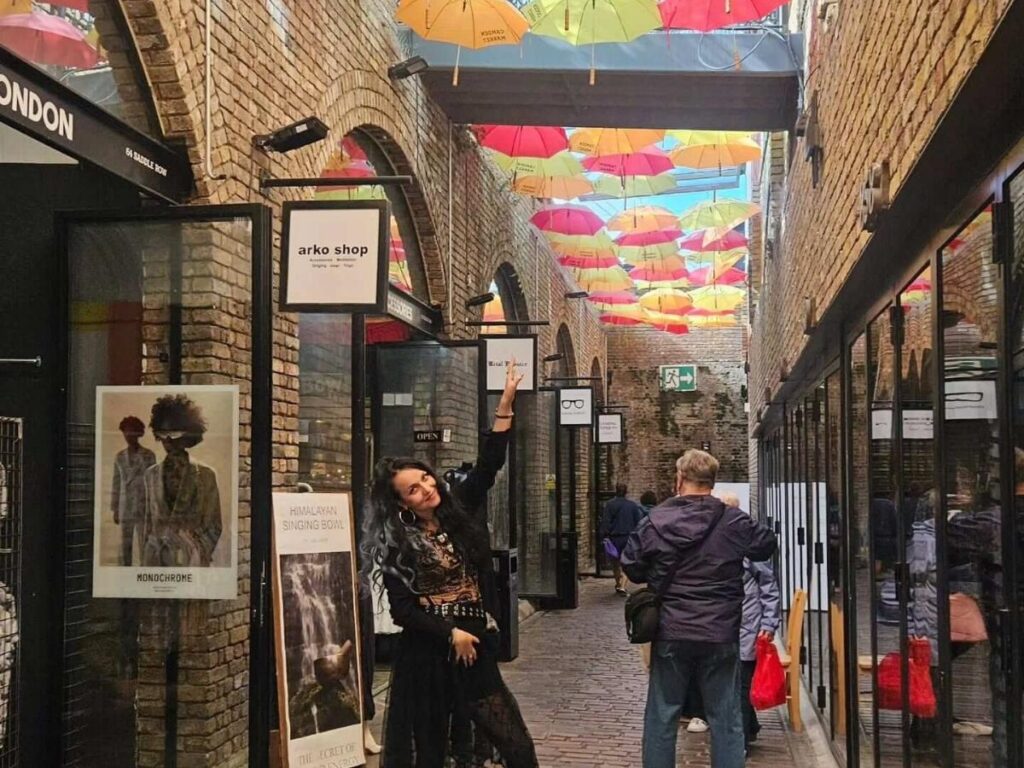 Regent’s Canal running through Camden Market with narrowboats and visitors walking along the towpath.