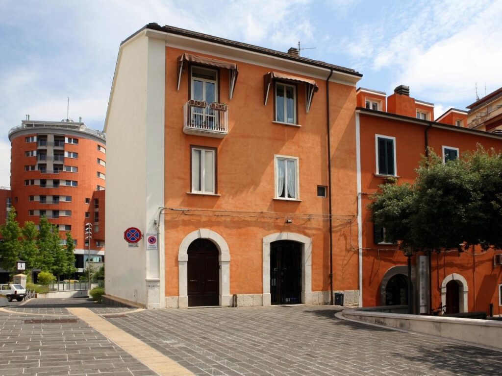 Narrow medieval lane and stone archways in Campobasso’s old town leading up toward Monforte Castle.