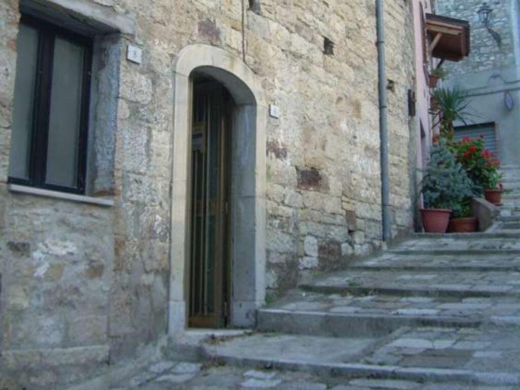 Narrow cobbled street lined with old stone houses in Campobasso’s medieval center.