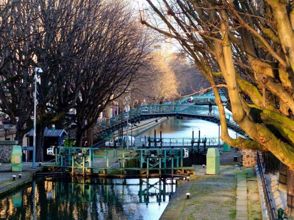 Canal Saint-Martin in Paris with locals walking and sitting by the water